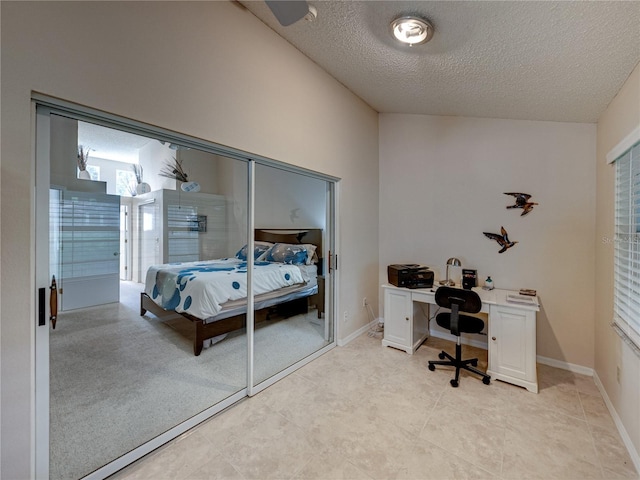 bedroom with a textured ceiling and a closet