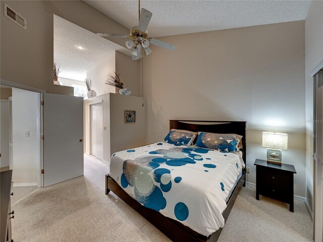 carpeted bedroom featuring lofted ceiling, ceiling fan, and a textured ceiling