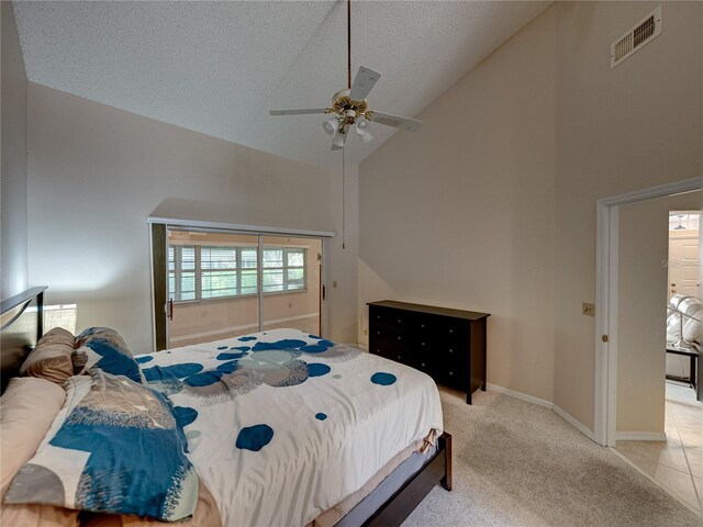 bedroom featuring ceiling fan, light colored carpet, high vaulted ceiling, and a textured ceiling