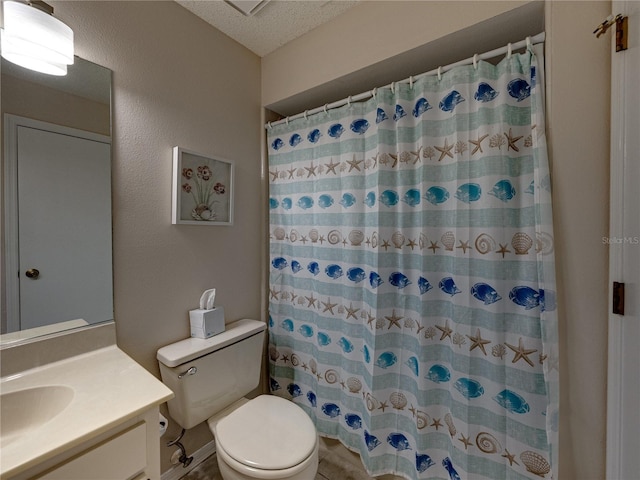 bathroom with vanity, toilet, a shower with shower curtain, and a textured ceiling