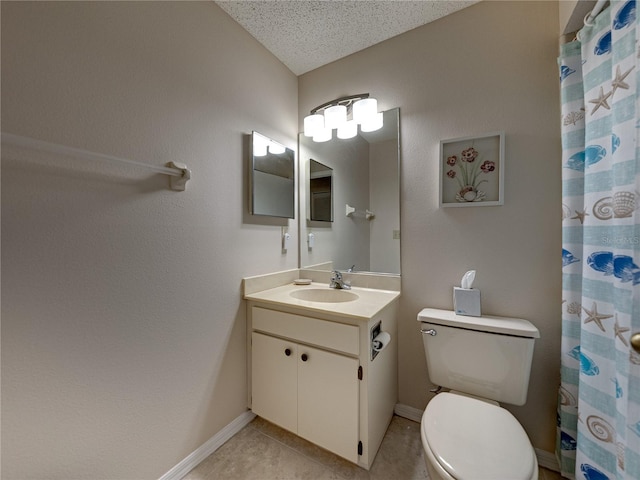 bathroom with tile patterned floors, vanity, a textured ceiling, and toilet