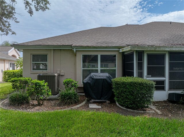 rear view of property with central air condition unit