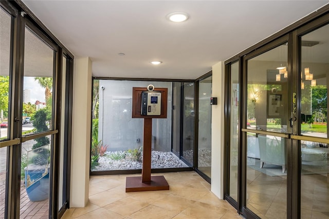 interior space featuring a wall of windows, french doors, and light tile patterned floors