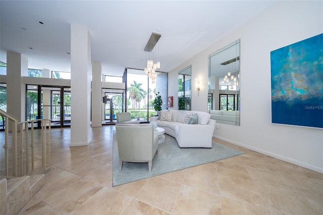 living room with a notable chandelier, a wealth of natural light, and light tile patterned floors