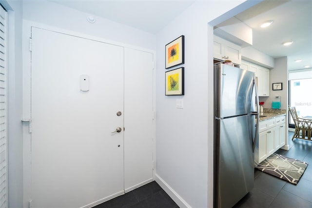 entryway featuring dark tile patterned flooring