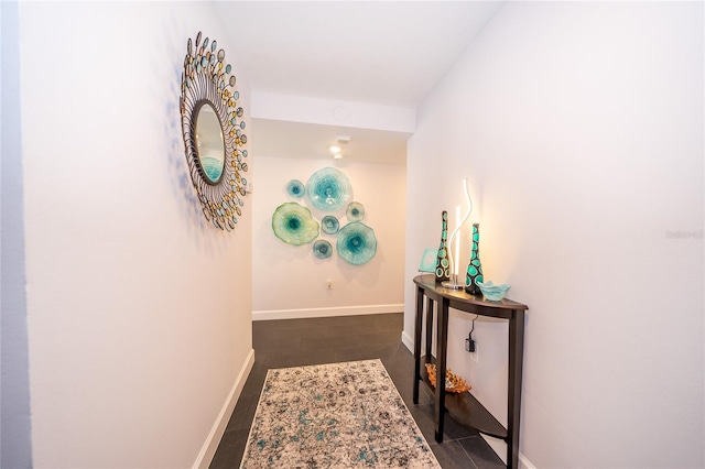 hallway with dark tile patterned floors