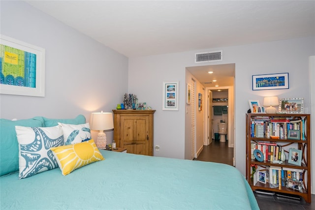 bedroom with dark hardwood / wood-style floors