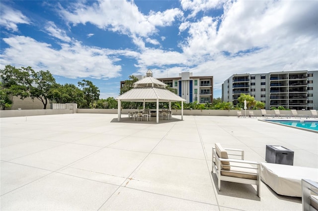 view of patio / terrace with a gazebo and a community pool