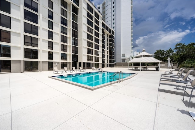 view of pool with a patio and a gazebo