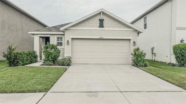 view of front of house featuring a garage and a front lawn