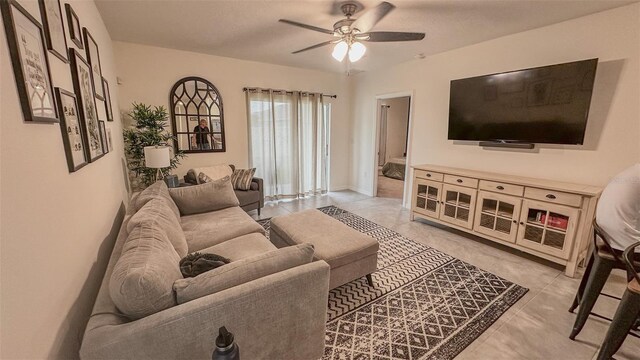 tiled living room featuring ceiling fan