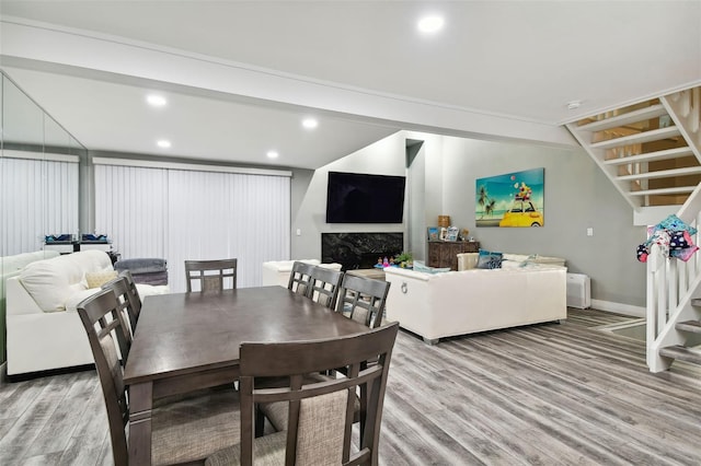 dining space featuring a fireplace and light hardwood / wood-style floors