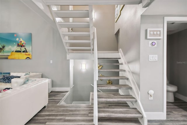 stairs with hardwood / wood-style floors