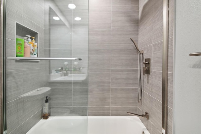 bathroom with shower / bath combination with glass door