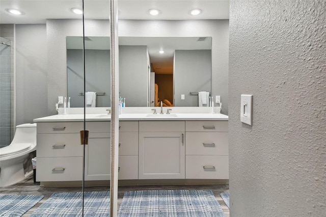 bathroom with vanity, toilet, and an enclosed shower