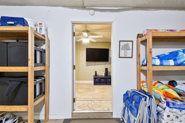 storage area featuring ceiling fan