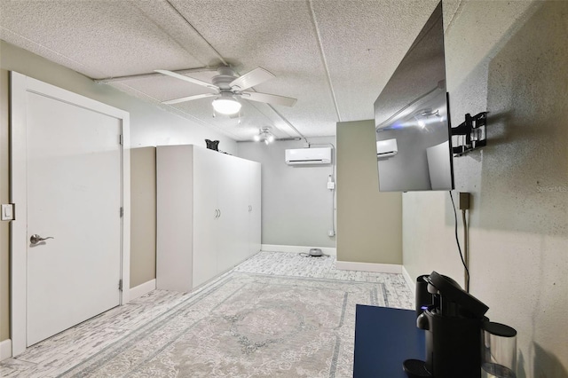 bathroom with an AC wall unit, a textured ceiling, and ceiling fan