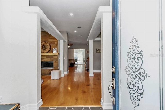 entryway with a fireplace and hardwood / wood-style flooring