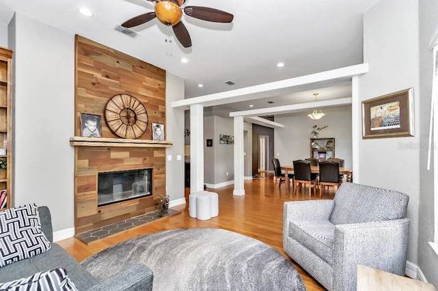 living room featuring ceiling fan and hardwood / wood-style flooring