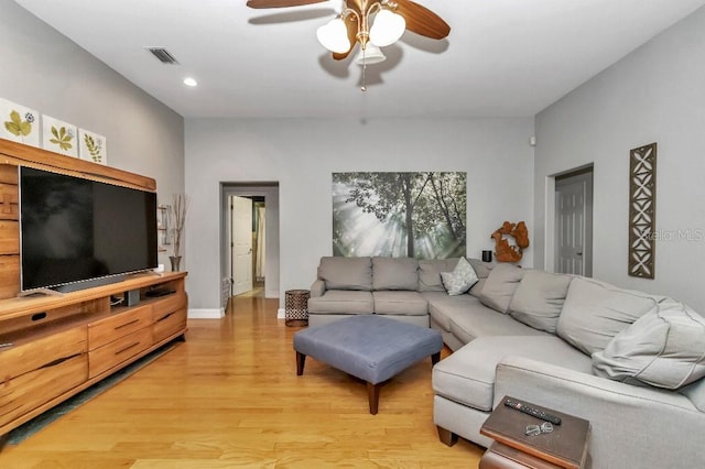 living room with light wood-type flooring and ceiling fan