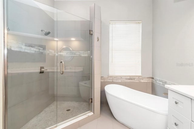 bathroom with vanity, a shower with door, and tile patterned flooring