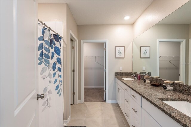 bathroom featuring dual vanity and tile patterned floors