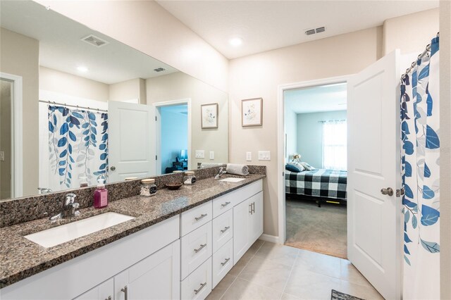 bathroom with dual vanity and tile patterned flooring