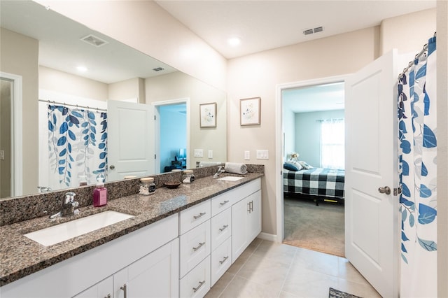 bathroom with vanity and tile patterned flooring