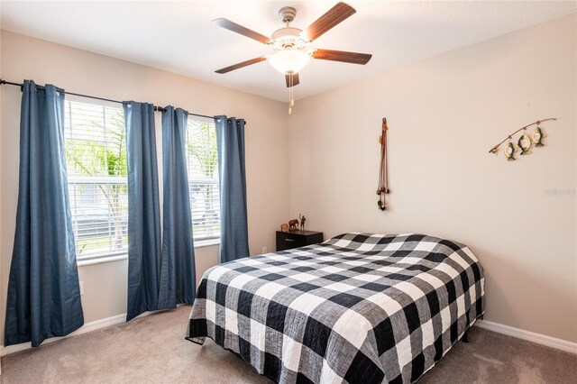 bedroom with light carpet and ceiling fan