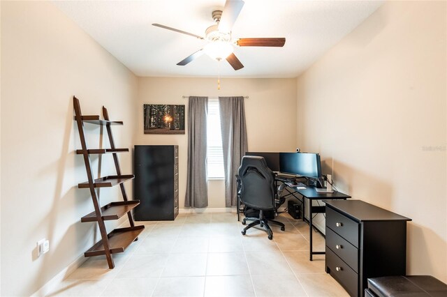 tiled office space featuring ceiling fan