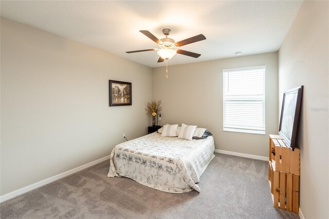 bedroom with ceiling fan and light colored carpet