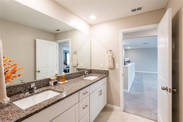 bathroom featuring tile patterned floors and double sink vanity