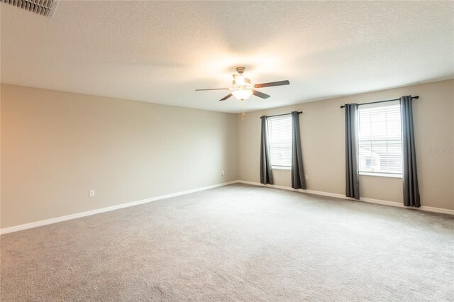 carpeted empty room featuring a textured ceiling and ceiling fan