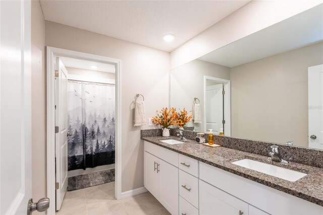 bathroom with tile patterned floors and double sink vanity