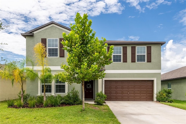 view of front of property with a front yard and a garage