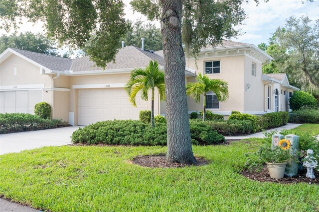 view of front of home featuring a garage and a front yard