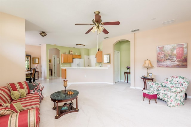 living room featuring light colored carpet and ceiling fan