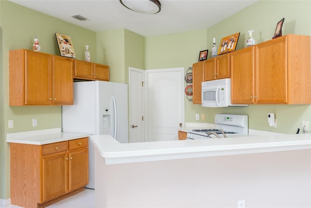 kitchen with white appliances and kitchen peninsula