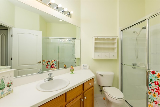 bathroom featuring vanity, an enclosed shower, and toilet