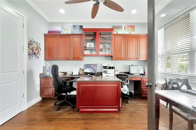 office featuring ornamental molding, dark hardwood / wood-style flooring, ceiling fan, and built in desk