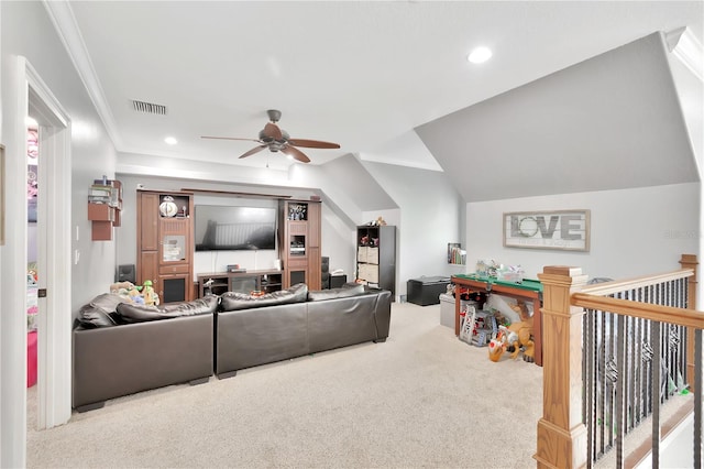 carpeted living room with vaulted ceiling, crown molding, and ceiling fan