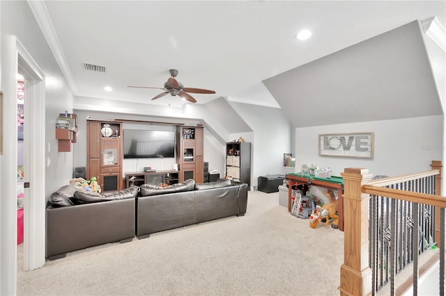 carpeted living room with crown molding and ceiling fan