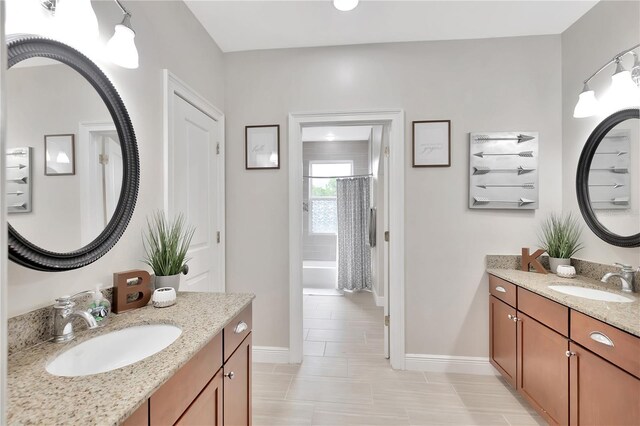 bathroom featuring tile patterned flooring, shower / bathtub combination with curtain, and dual bowl vanity