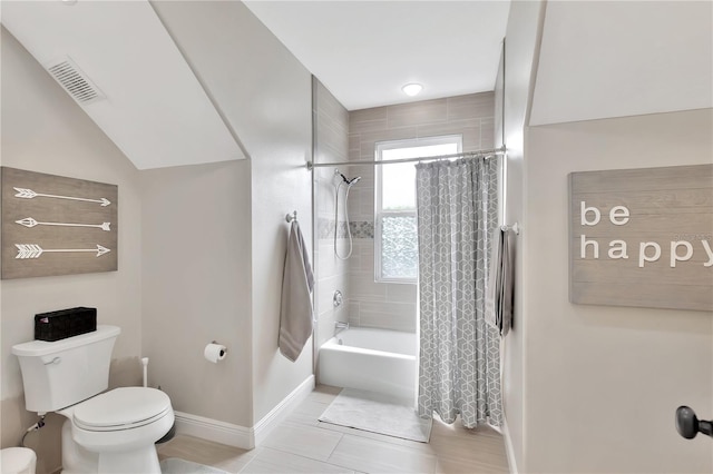 bathroom featuring shower / tub combo with curtain, tile patterned floors, and toilet