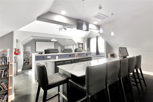 interior space featuring dark wood-type flooring and lofted ceiling