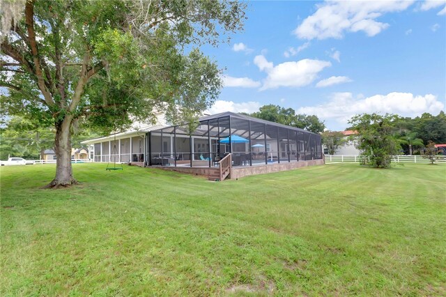 view of yard with glass enclosure