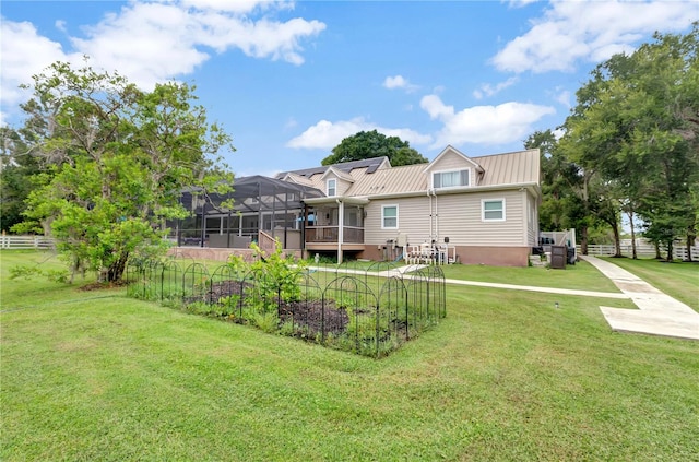 exterior space featuring a lawn and glass enclosure