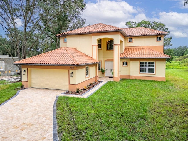 mediterranean / spanish-style home featuring a front yard