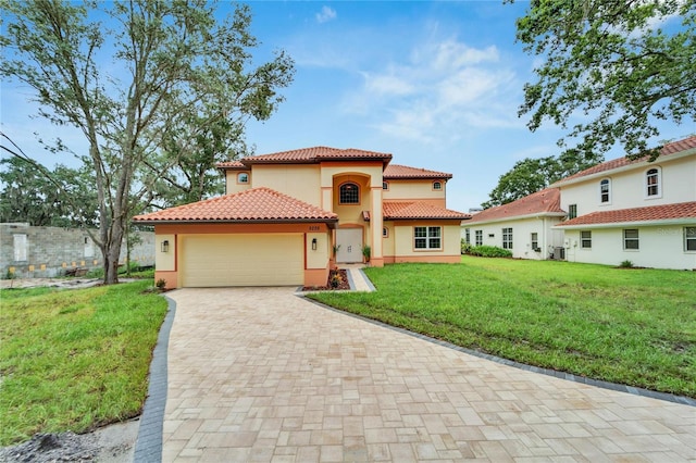 mediterranean / spanish-style house featuring a garage and a front lawn