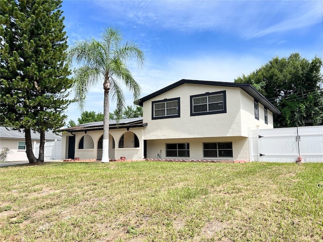 tri-level home with a front yard